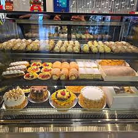 The cake cabinet filled with cannoli, pastries and whole cakes